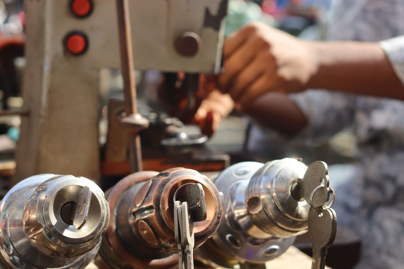 Locksmith working hands-on with lock cylinders and tools during a service call
